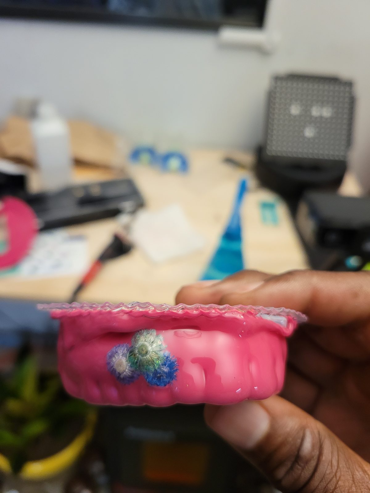 Custom hot-pink mouthguard with floral accents held in hand